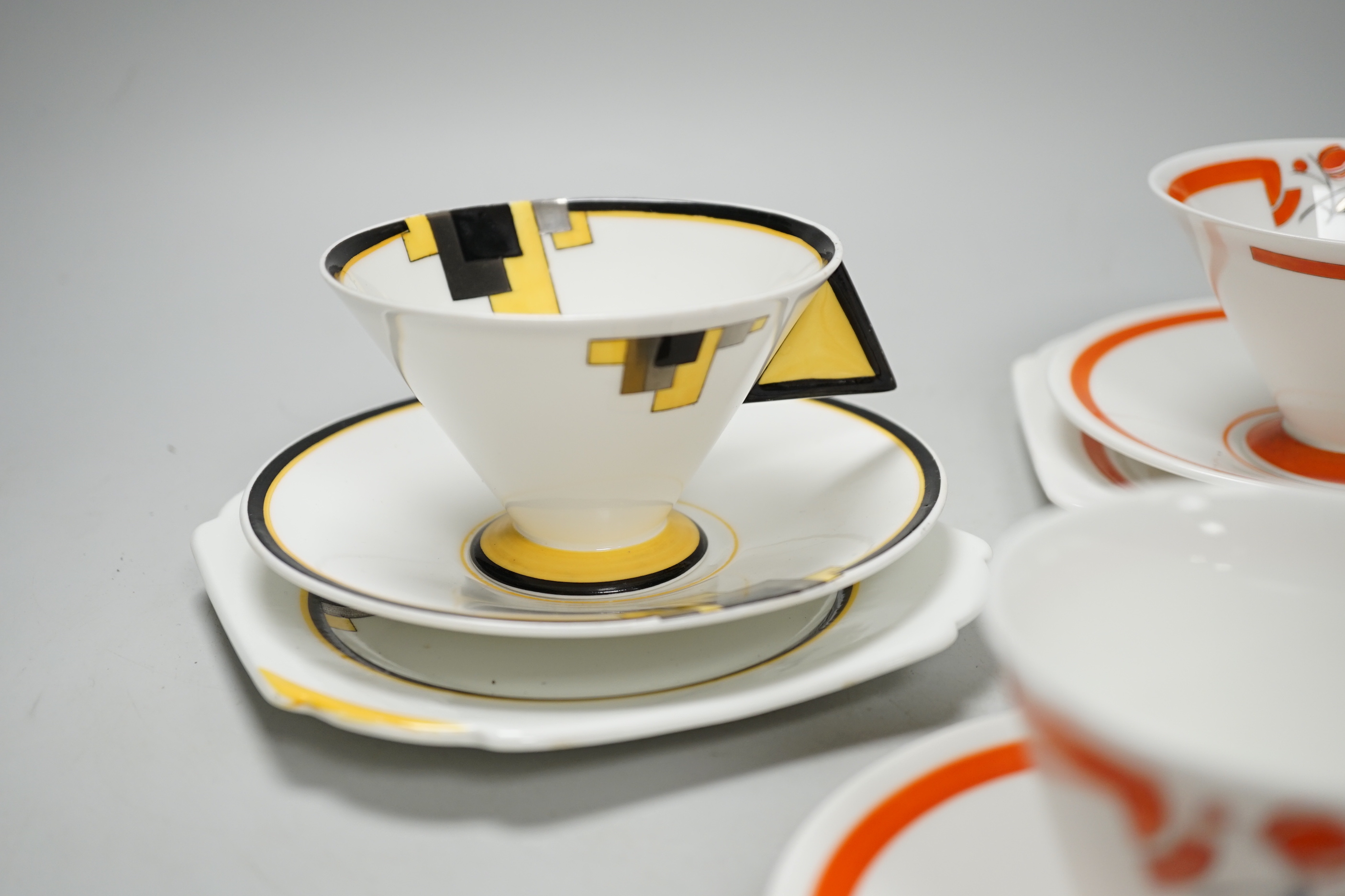 Two Art Deco Shelley Vogue shaped handled trios and a cup and saucer, largest cups 6.5cm high